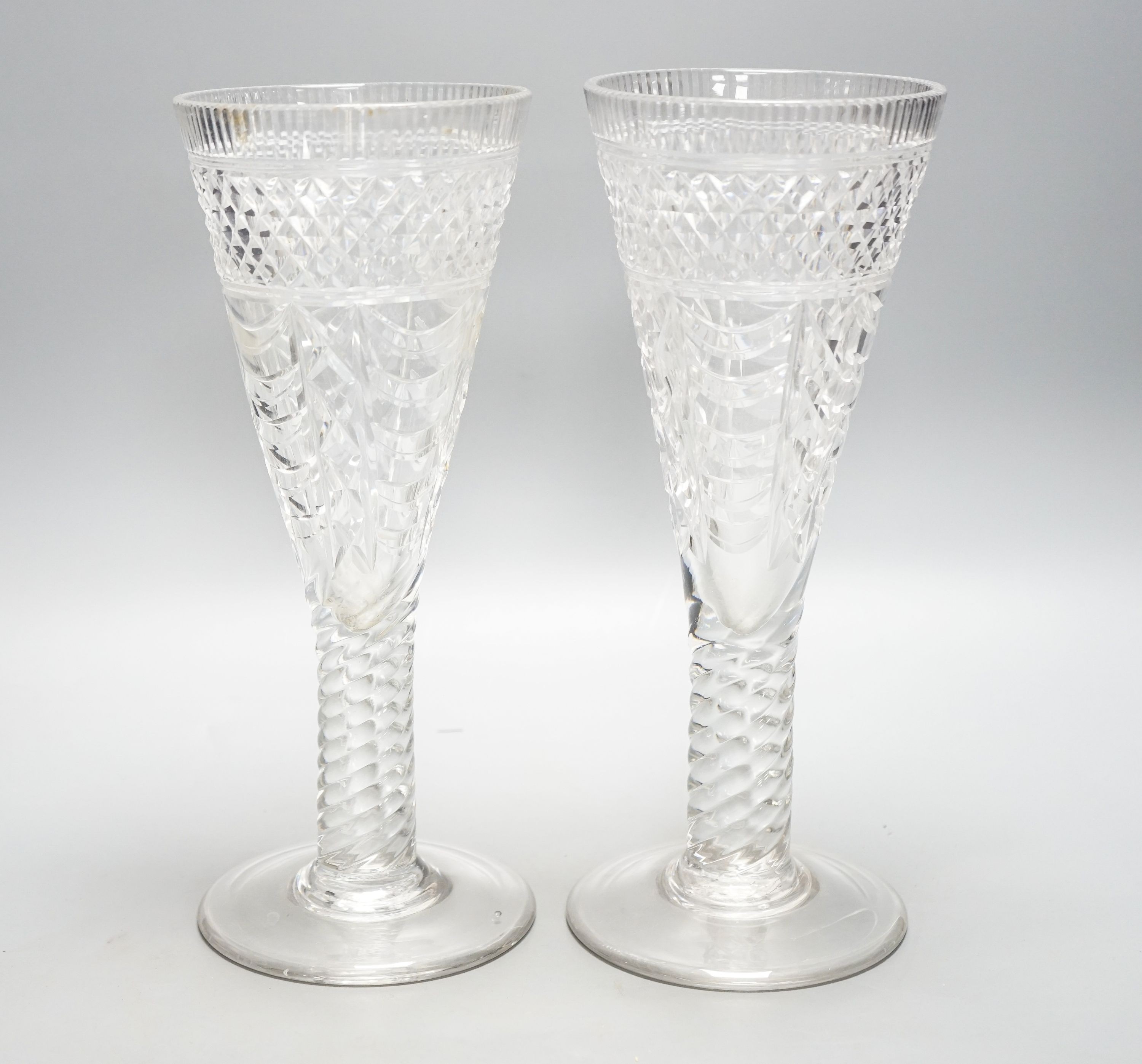 A pair of 19th century large glass goblets or vases, each on spiral-twist stem and circular foot with pontil mark 30cm
